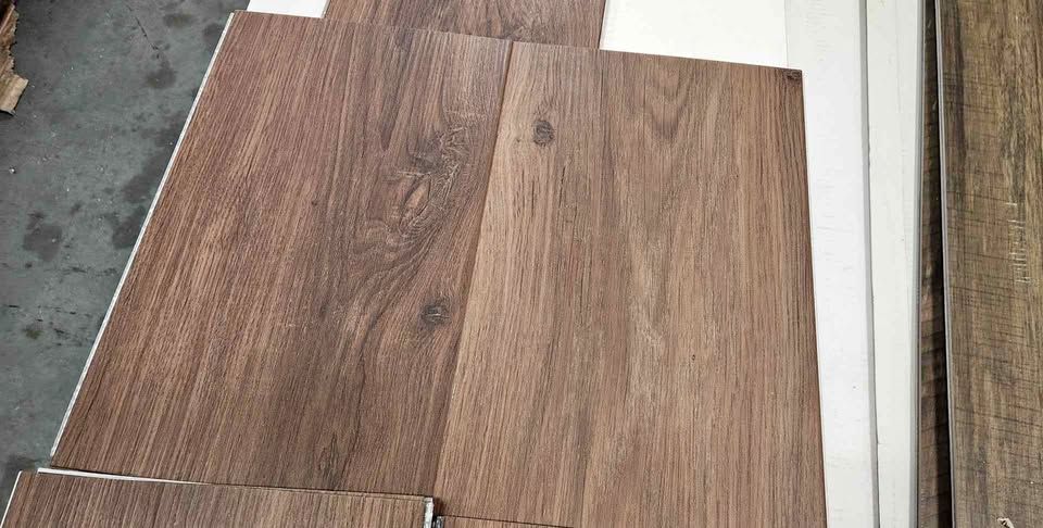 Dover luxury vinyl plank flooring sample in a warm brown wood look