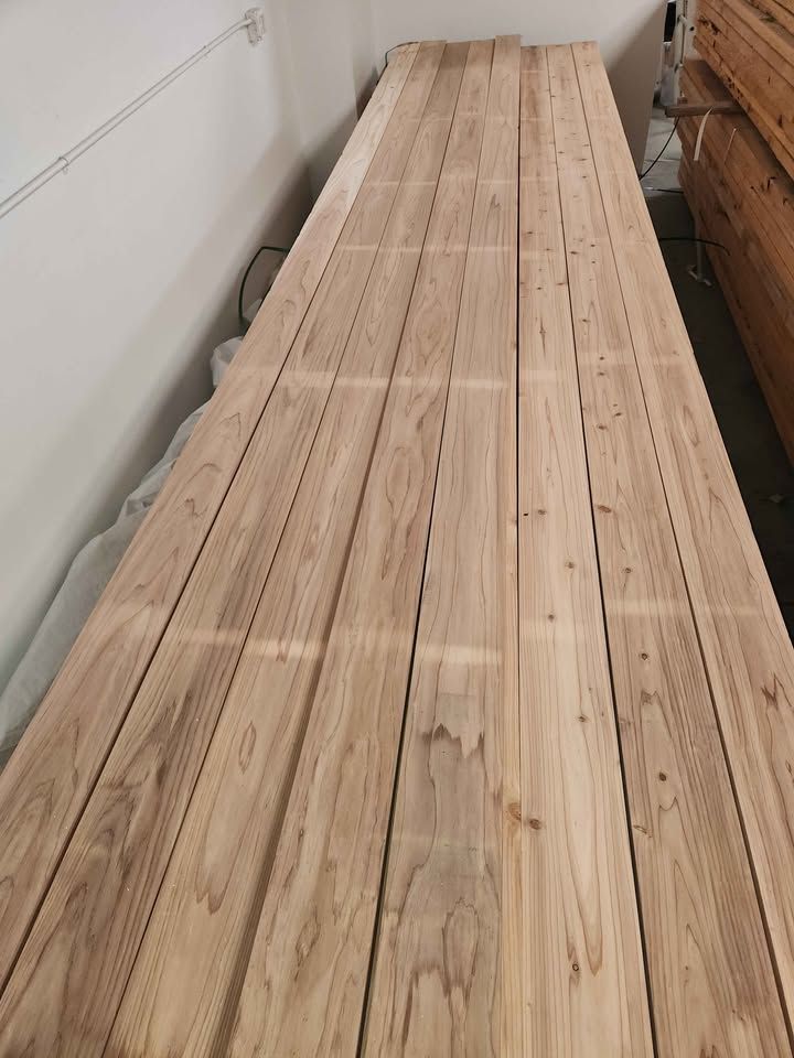 Long Japanese Sugi cedar 2x6x16 boards laid out on a warehouse floor