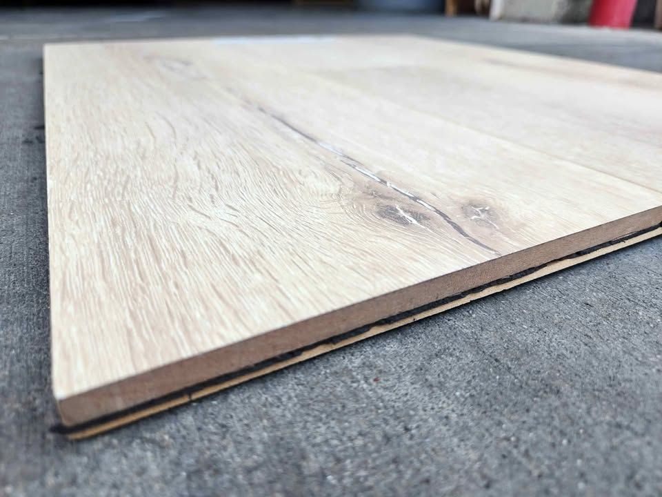 Light oak-look hybrid waterproof laminate plank on a shop floor