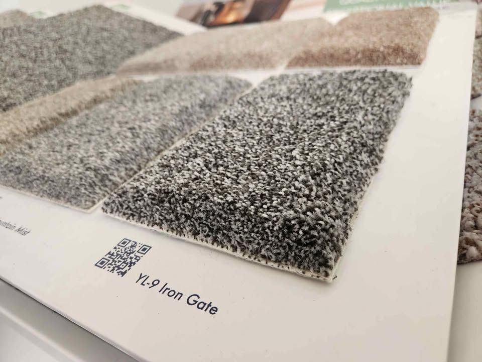 Gray plush carpet samples on a display board