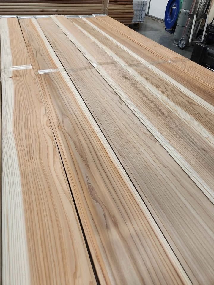 Japanese Sugi cedar 1x6 tongue and groove boards laid out, showing pale sapwood and reddish heartwood stripes